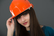 Businesswoman with construction helmet. Isolated on gray