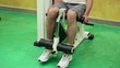 Man exercising in the gym, quadriceps working out