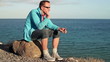 Sad, depressed young man sitting by the sea