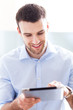 Photo: Man looking at digital tablet Man looking at digital tablet