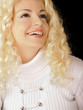 Beautiful young woman with curly blond hair, smiling