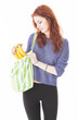 Happy woman put fruit in eco friendly cloth bag