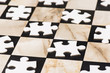 Blank puzzle pieces on chess board