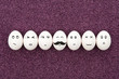 Seven eggs on purple sand.