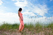 girl in pink dress on seacoast