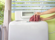 woman putting a cloth into washing machine