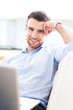 Photo: Man on sofa with laptop Man on sofa with laptop