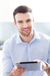 Photo: Young man using digital tablet Young man using digital tablet