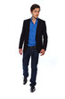 Walking young business man wearing blue jacket and jeans. Isolat