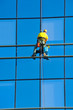 Washer wash the windows of modern skyscraper
