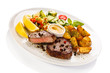 Grilled steak, baked potatoes and vegetables