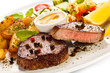 Photo: Grilled steak, baked potatoes and vegetables Grilled steak, baked potatoes and vegetables