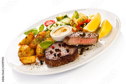 Photo: Grilled steak, baked potatoes and vegetables Grilled steak, baked potatoes and vegetables