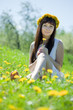  girl sitting  in dandelion meadow