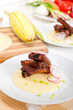 pork ribs on polenta corn cream bed