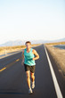 Male runner jogging and running on road in nature