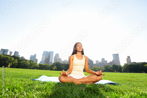 Photo: Meditating woman in meditation in New York park Meditating woman in meditation in New York park
