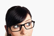 Cropped image a young woman's face with her eyes looking at corn