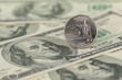 Hawaii State Quarter coin on one hundred dollar bills close up
