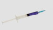 Focus on syringe holding blue liquid