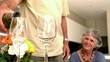 Man pouring glass of wine for his wife