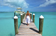 Girl on the wooden jetty looking to the ocean. Exuma, Bahamas