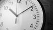 Clock falling over papers showing data and graphs