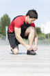 Athlete tying the laces of his shoes