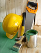 green wood floor with a brush, saw, hammer and helmet
