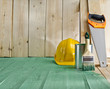 green wood floor with a brush, saw and helmet