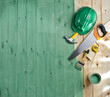 green wood floor with a brush, paint, tools and helmet