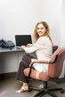 Smiling woman sitting at office desk