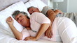 Mature couple sleeping together