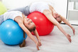 Photo: Woman and little girl doing stretching exercises Woman and little girl doing stretching exercises