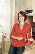 Smiling woman in kitchen at home
