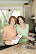 Two women doing dishes in kitchen