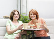 Mother and daughter relaxing in backyard