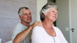 Woman enjoying shoulder massage given by her husband