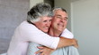 Mature woman cuddling her husband