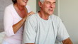 Man enjoying shoulder massage given by his wife