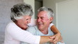 Mature couple laughing and embracing together
