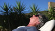 Mature woman sunbathing in a deckchair