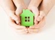 couple hands holding green house