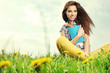 Beautiful girl lies on meadow and reads the boo