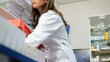 Female pharmacist controlling medicine drugs pills