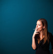 Beautiful woman smoking cigarette vith copy space
