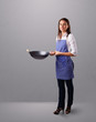 Young lady holding a frying pan