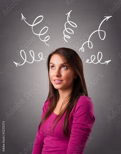 Photo: Young woman thinking with arrows overhead Young woman thinking with arrows overhead