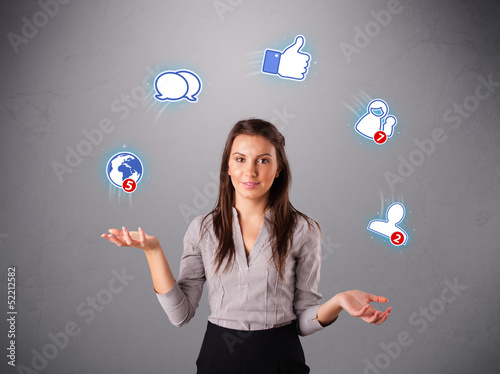 Photo: attractive young woman juggling with social network icons attractive young woman juggling with social network icons