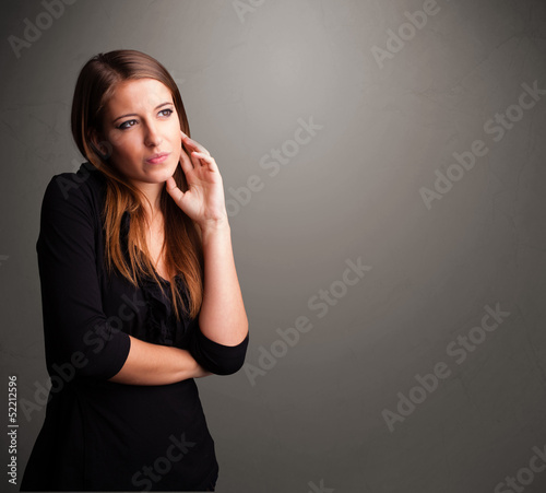 Photo: Beautiful woman thinking with empty copy space Beautiful woman thinking with empty copy space